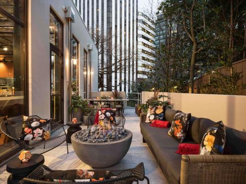 a patio with a fire pit in the middle of a building at Sofitel Wellington in Wellington