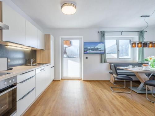 a kitchen and dining room with a table and chairs at Roßbrand und Tauern-Blick in Untertauern