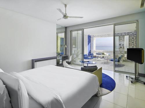 a bedroom with a bed and a view of the ocean at Sofitel Tamuda Bay Beach And Spa in M'diq
