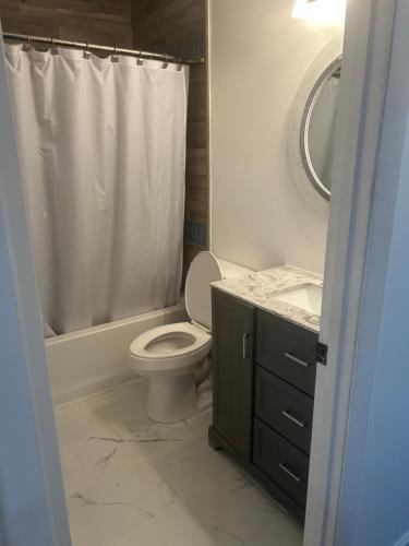 a bathroom with a toilet and a sink and a shower at Vacation Bliss LLC in Hilton Head Island