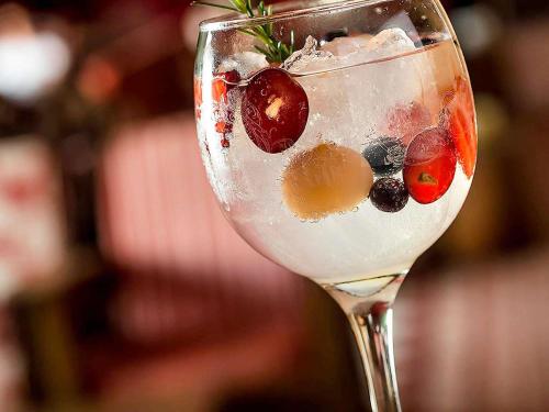 a glass with fruit and ice in a drink at Santa Teresa Hotel Rio de Janeiro - MGallery Collection in Rio de Janeiro