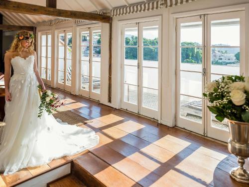a bride in a wedding dress in a room with windows at Santa Teresa Hotel Rio de Janeiro - MGallery Collection in Rio de Janeiro