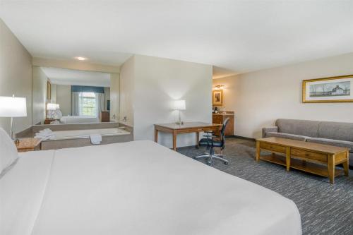 a hotel room with a bed and a couch at SureStay Plus Hotel by Best Western Elizabethtown Hershey in Elizabethtown