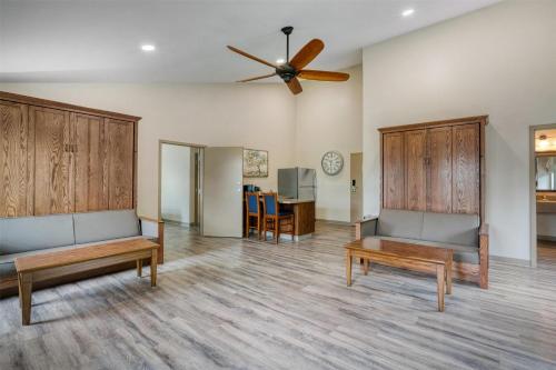 a living room with two beds and a ceiling fan at SureStay Plus Hotel by Best Western Elizabethtown Hershey in Elizabethtown