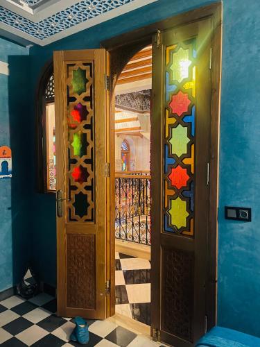 an entrance to a room with a door with stained glass at Riad Qasr El Medina in Tangier