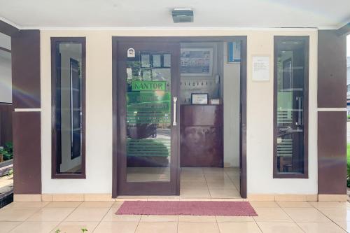 an entrance to a restaurant with a revolving door at RedDoorz at Hotel Mutiara Kuningan in Sangkanurip
