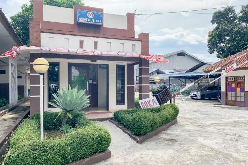 a building with a sign on the side of it at RedDoorz at Hotel Mutiara Kuningan in Sangkanurip