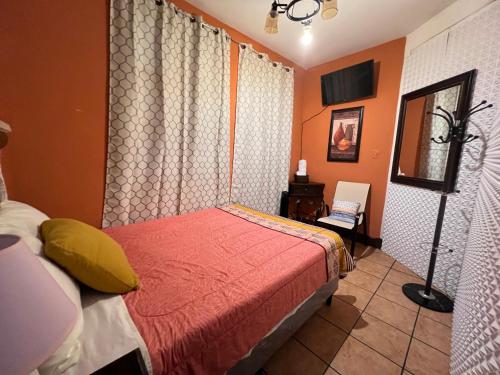a bedroom with a bed and a lamp in it at Hotel y Restaurante San Fernando. in Jocotenango