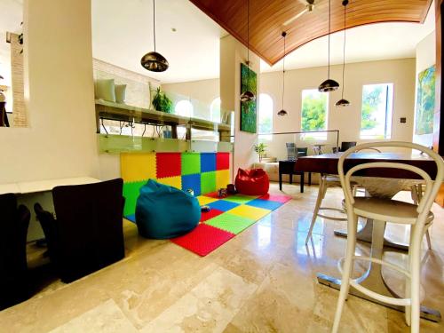 a dining room with a colorful rug on the floor at Hotel Boutique Bovedas de Santa Clara By Accor in Cartagena de Indias