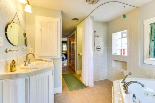 a white bathroom with a tub and a sink at Walk to Mueller Lake Park! Home with Patio and Yard in Austin