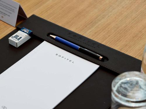 a pen sitting on top of a desk at Sofitel Sydney Darling Harbour in Sydney