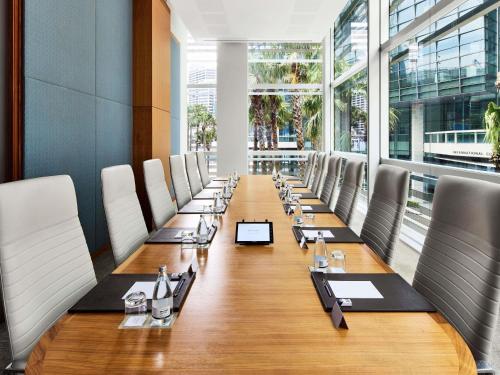 a long conference room with chairs and a long table at Sofitel Sydney Darling Harbour in Sydney