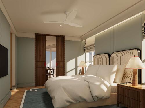 a bedroom with a large white bed and a mirror at Sofitel Noosa Pacific Resort in Noosa Heads
