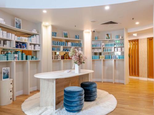 a room with a table and two blue stools at Sofitel Noosa Pacific Resort in Noosa Heads