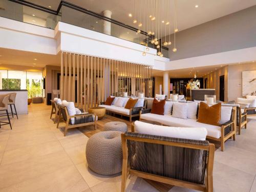 a large living room with couches and chairs at Sofitel Noosa Pacific Resort in Noosa Heads