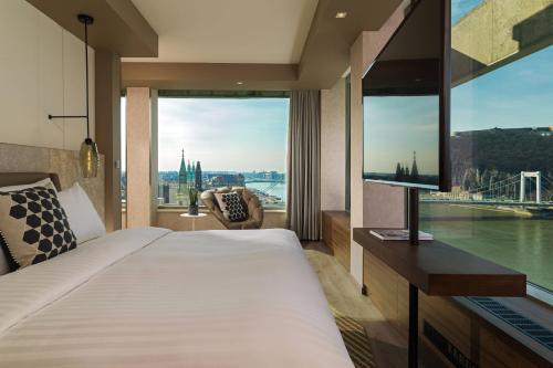 a hotel room with a bed and a large window at Budapest Marriott Hotel in Budapest
