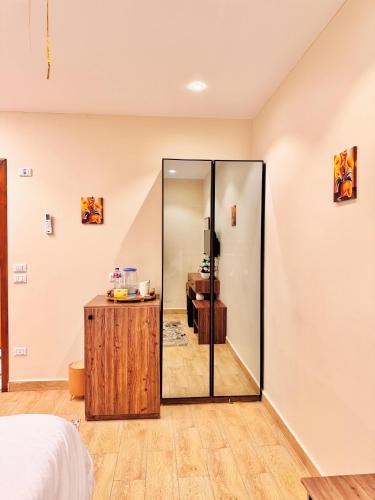 a bedroom with a glass door leading into a bathroom at Amon Pyramids View Inn in Cairo