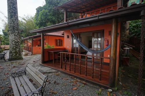 a house with a hammock on the outside of it at Casa da Ilha & SPA in Abraão