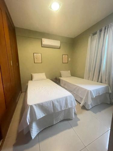 two beds sitting in a room withermottermottermott at Rent in the Heart of COP 30 Belém in Belém