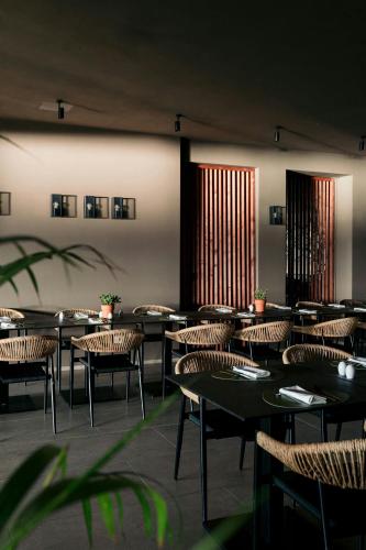 a group of tables and chairs in a restaurant at Mangia's Brucoli, Sicily, Autograph Collection in Brucoli