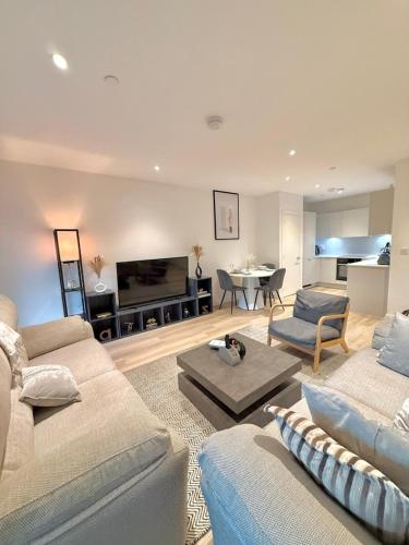 a living room with two couches and a table and a piano at Quiet Hideaway in London