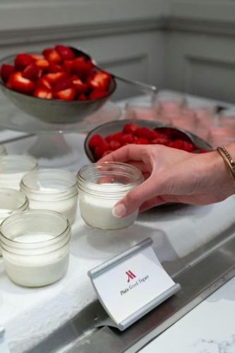 a person is reaching for a bowl of whipped cream at Westfields Marriott Washington Dulles in Chantilly