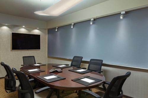 a conference room with a table and chairs and a large screen at The Westin New York at Times Square in New York