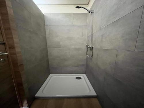a bathroom with a shower with a toilet in it at Camping tent with modern amenities in Trois-Ponts