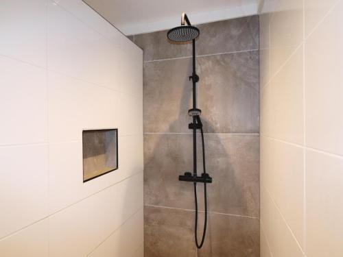 a shower in a bathroom with a shower head at Beautifully styled apartment in Engelum