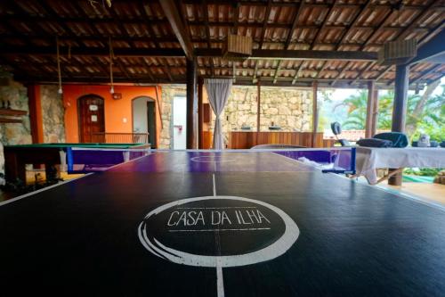 a table with a logo on the top of it at Casa da Ilha & SPA in Abraão