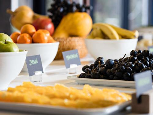 a display of fruits and vegetables in bowls on a table at Tarcin Forest Resort & Spa Sarajevo - MGallery Collection in Tarčin