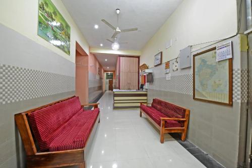 a hallway with two benches in a hospital at Super Hotel O Vellore New Bus Station Formerly SP Highway Inn in Vellore