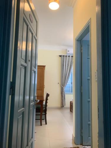 an open door to a hallway with a dining room at Areca Homestay in Hoi An