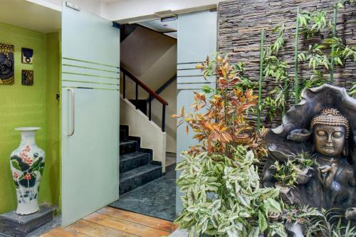 a house with a statue of a buddha on the wall at Super Townhouse Viman Nagar Business Stay Formerly Silver Crest in Pune