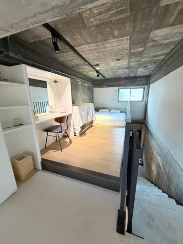 a room with a bed and a desk in it at RePORTHOTEL in Yaizu