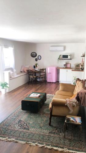a living room with a couch and a table at The Dairy at Cambewarra Estate Winery in Camberwarra