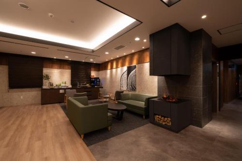 a lobby of a hotel with a fireplace at ホテルエノエ富山 in Toyama