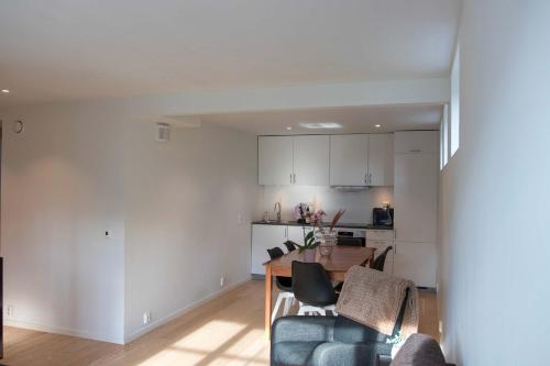 une cuisine et un salon avec une table et des chaises dans l'établissement Arctic View 2-Bedroom Apartment, à Tromsø