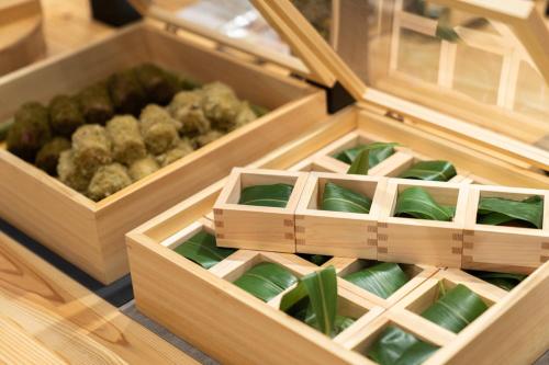 two wooden boxes with green plants in them at ホテルエノエ富山 in Toyama