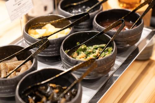 a group of bowls of food on a tray at ホテルエノエ富山 in Toyama