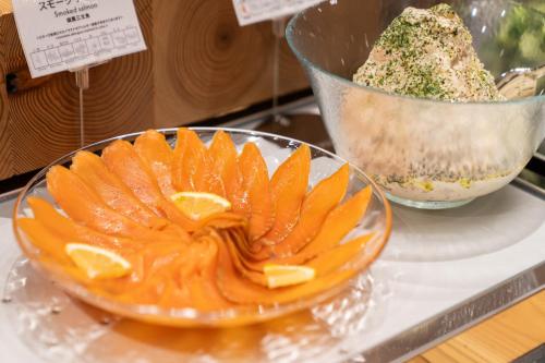 an orange dessert in a glass bowl on a counter at ホテルエノエ富山 in Toyama