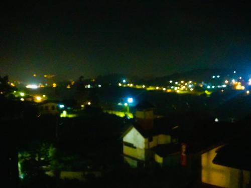 a view of a city at night with lights at Serendipity Lake Artistic Bungalow by Heidis Home in Nuwara Eliya