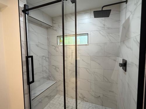 a shower with a glass door in a bathroom at Snowshoe Motel in Frisco