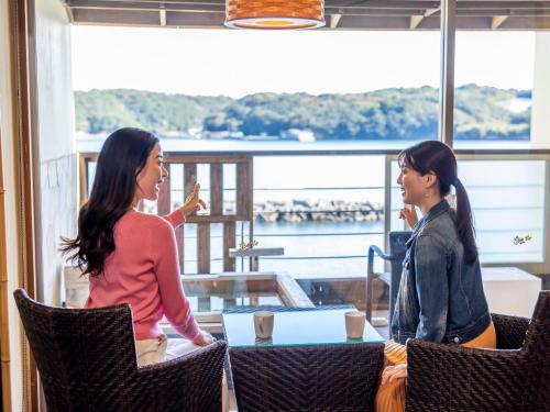 two women sitting at a table talking at Haifu in Shima