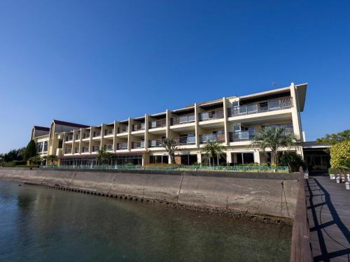 a large building next to a body of water at Haifu in Shima