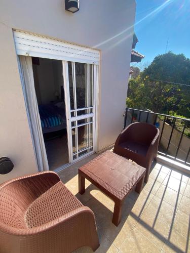 a room with a balcony with a chair and a table at Duplex 3 - Calle 15 in San Clemente del Tuyú