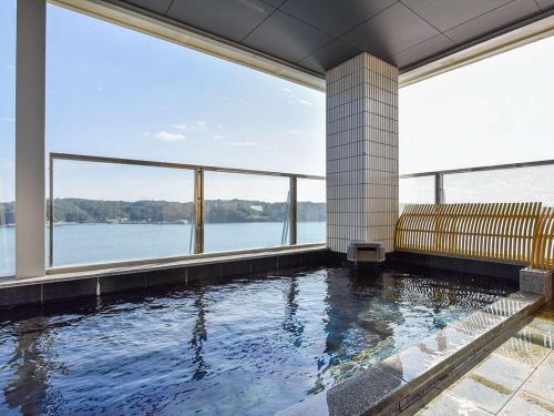 a swimming pool with a view of the water at Haifu in Shima