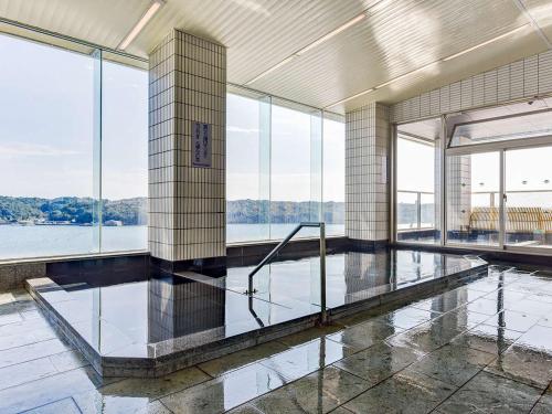 a large room with glass windows and a floor of water at Haifu in Shima