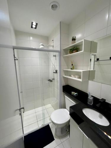 a bathroom with a shower and a toilet and a sink at Studio Mogi das Cruzes in Mogi das Cruzes