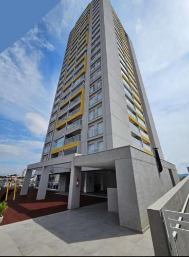 a tall building with yellow windows on top of it at Studio Mogi das Cruzes in Mogi das Cruzes